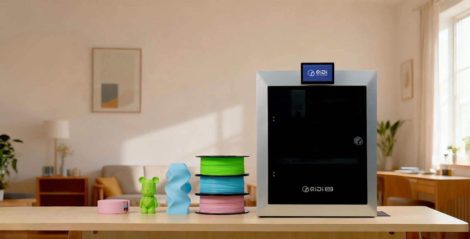 A white QIDI 3D printer on a wooden desk in a home, surrounded by colorful filament spools and various 3D printed creations